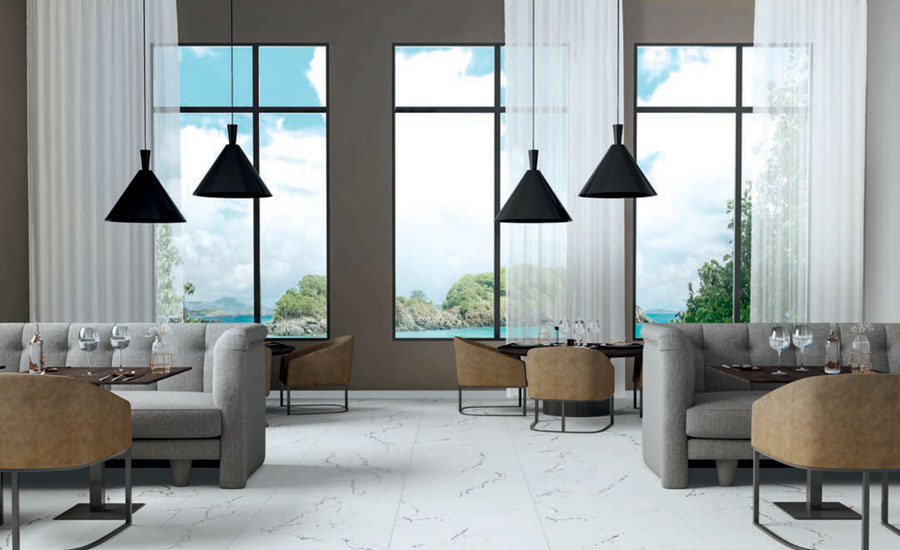 A living room with marble-effect tiles and a sea view