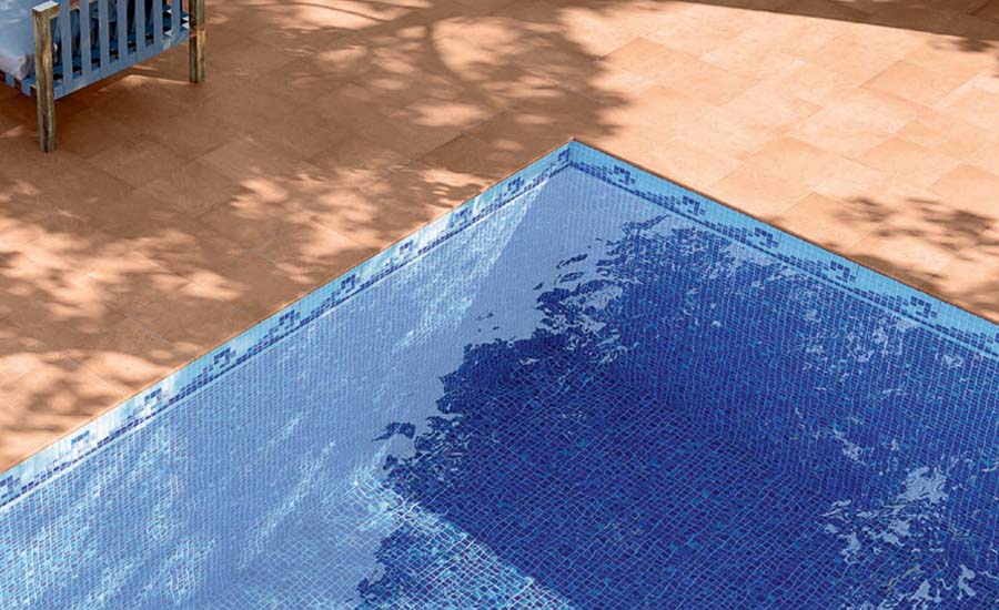 A Mediterranean-style courtyard with warm terracotta and patterned Spanish tiles