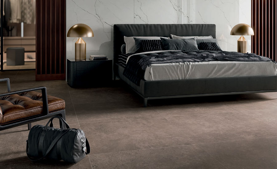 A bedroom with dark flooring